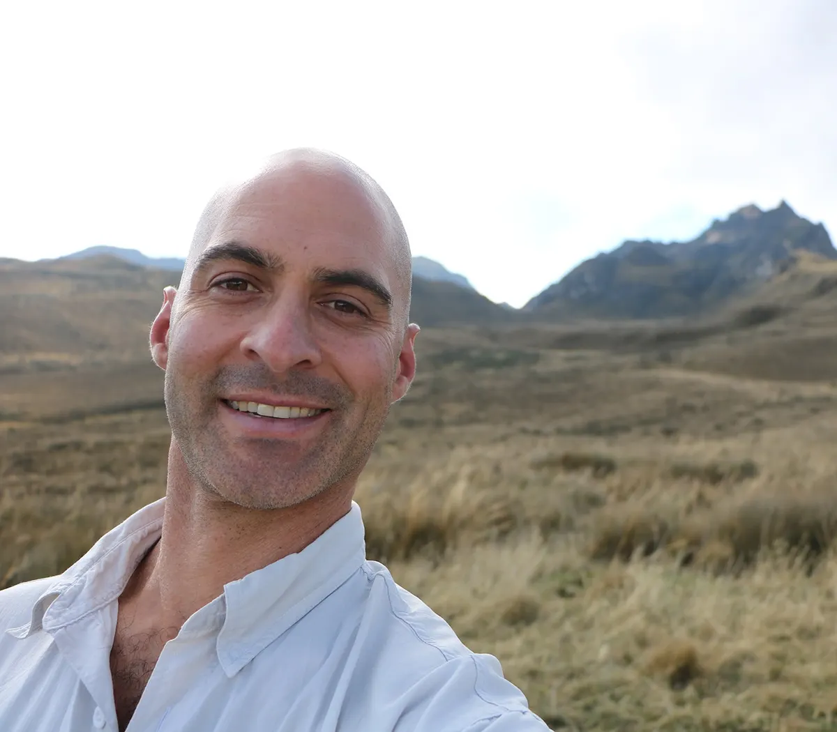 Dr. Kerry Kriger in the Andes above Quito, the peaks of Pichincha behind him